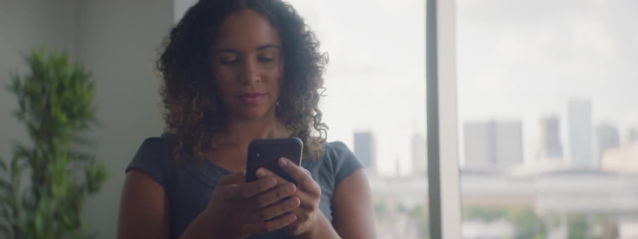 A woman tapping on her phone
