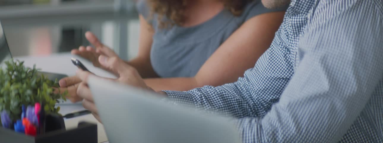 A woman and man are looking at a cell phone