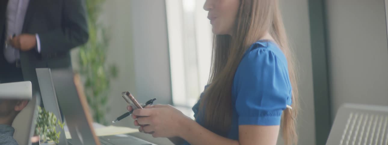 A woman is on her cellphone and talking to people
