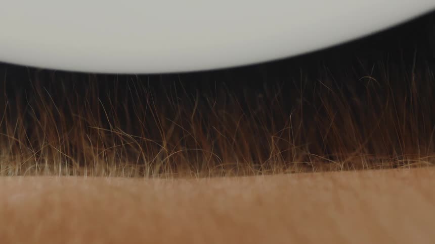 Arm hair rising towards a balloon