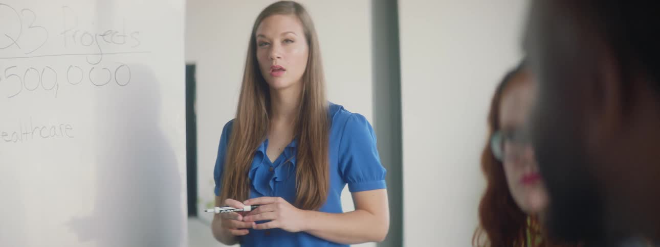 A woman is talking to people in a room