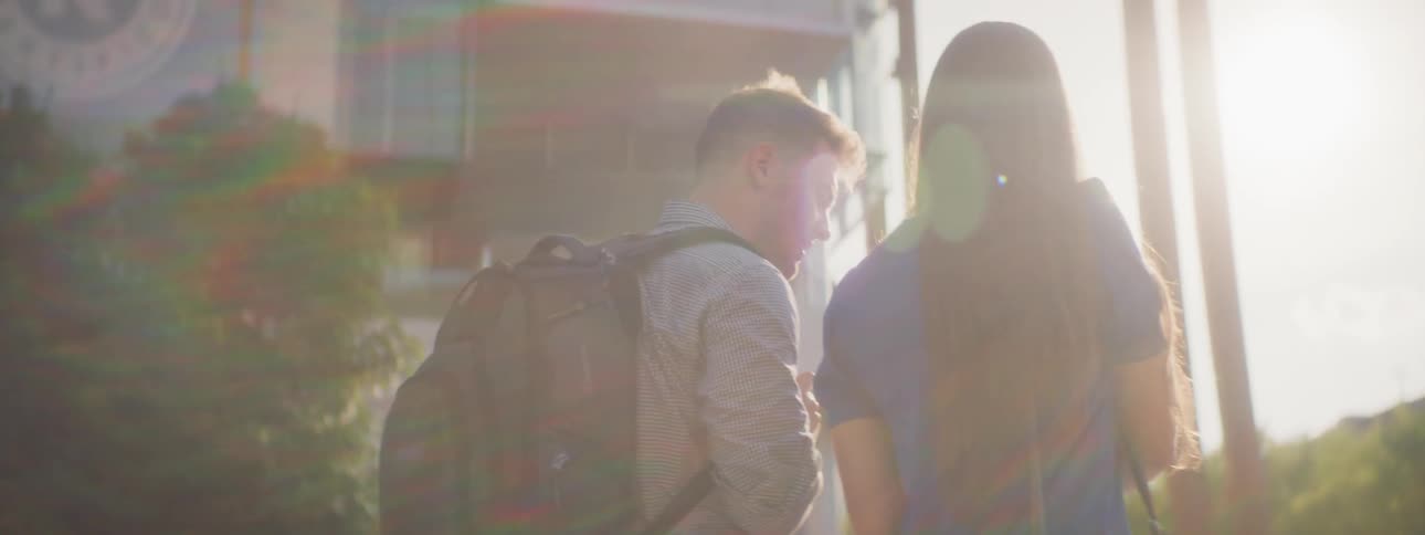 Man and women walk together on college campus