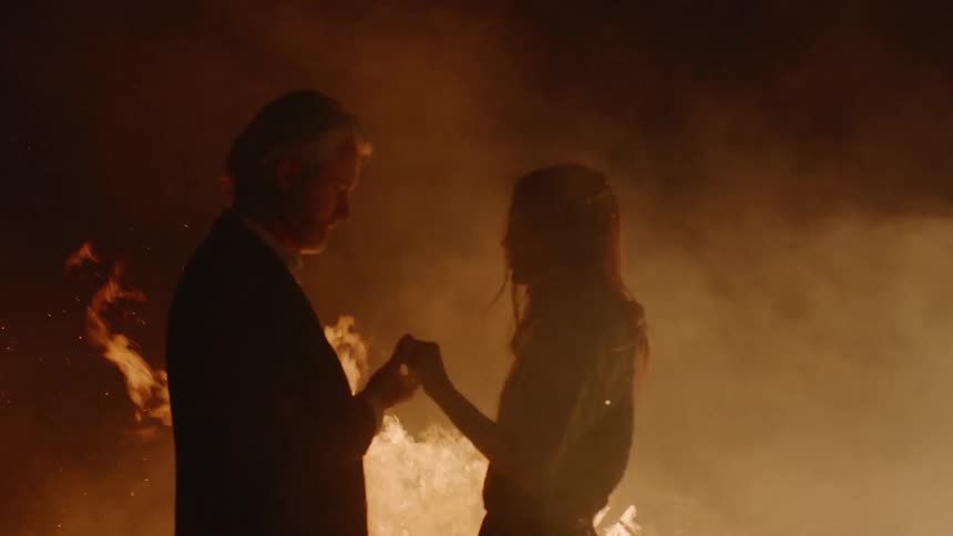 A man and woman holding hands outside