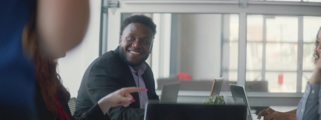People sit at a table talking and laughing