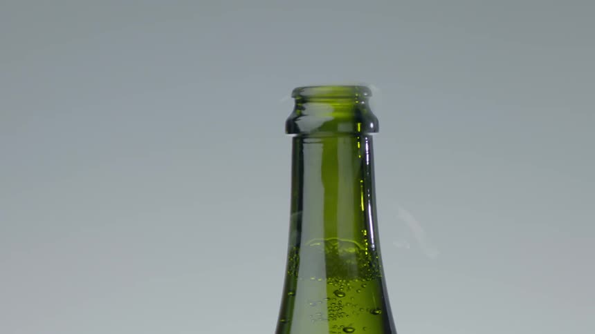 Water vapor coming out of top of fizzy soda bottle