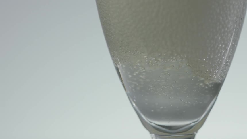 A champagne glass being filled