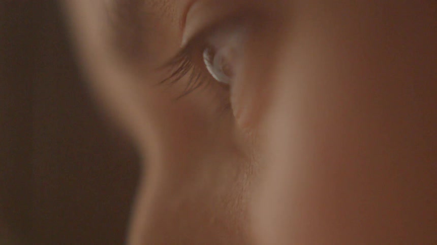 An eyes stares down without blinking