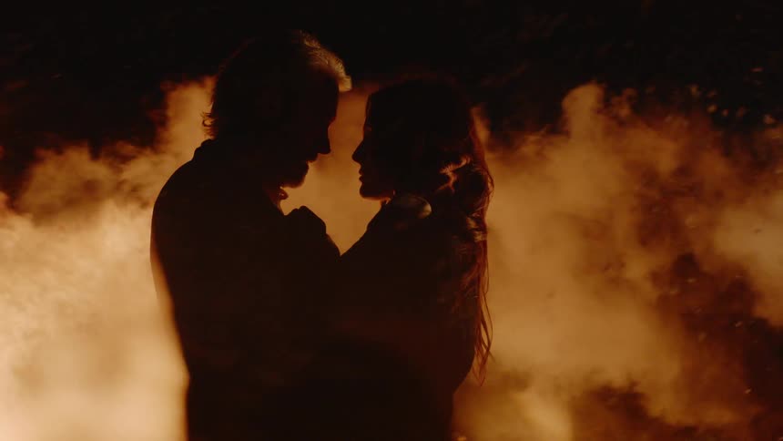 A man and woman holding each other outside