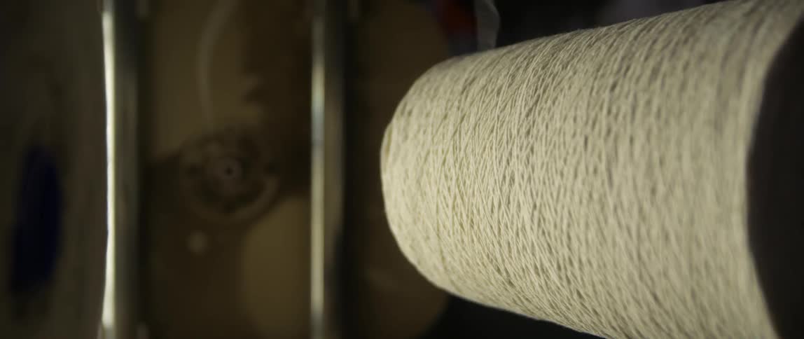 A string of yarn being spun off a roll