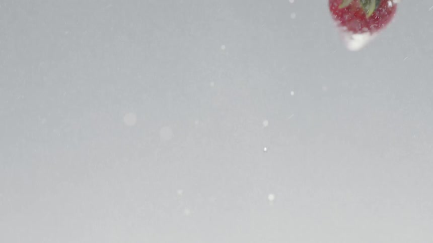 Wet strawberries fly through the air
