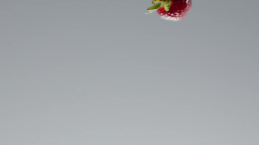 A strawberry is thrown into the air