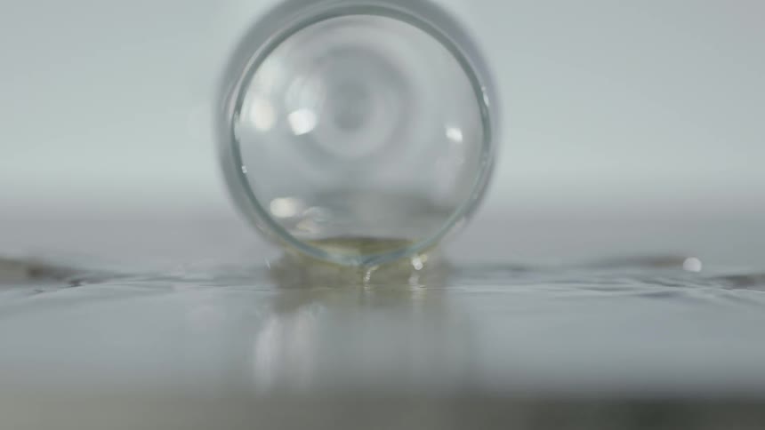 Champagne glass tips over and spills champagne