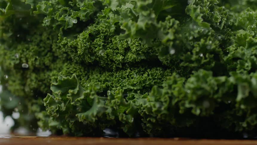 A vegetable is being thrown onto a table