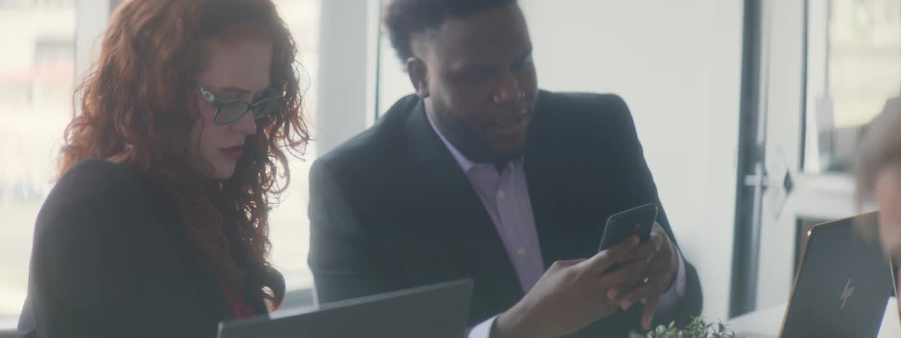 Man shows coworker cell phone