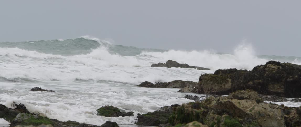 Ocean waves crash into a rocky shore