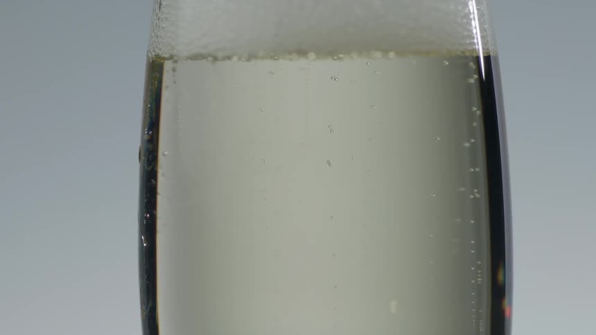 Bubbles float in a glass of champagne