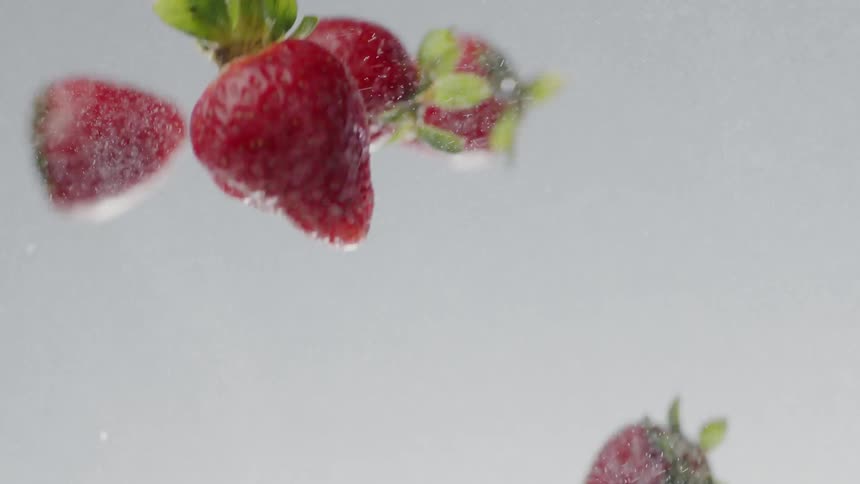 Strawberries and powder are tossed in the air