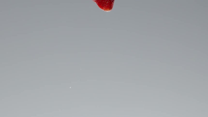 A strawberry being thrown in the air