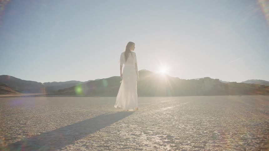A woman strolling in a sunny desert