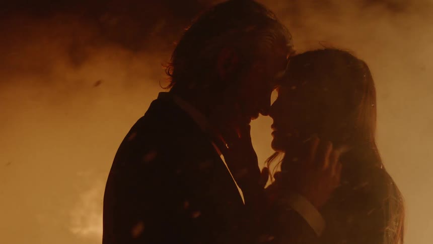 A man and woman holding each other outside