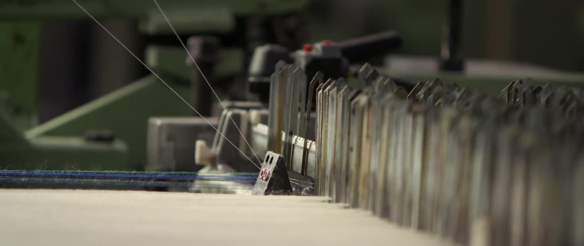 Industrial machines go up and down as they sew thread