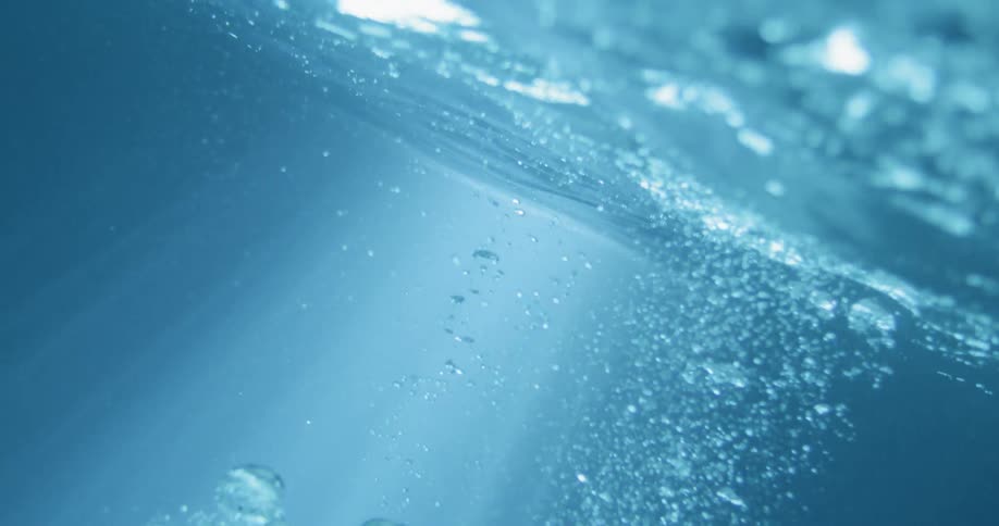 Air bubbles flowing underwater towards the surface