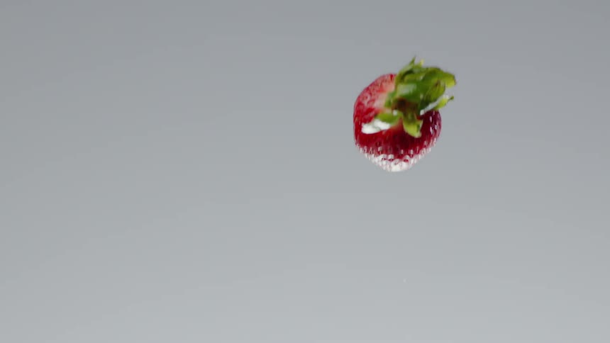 A strawberry being thrown in the air