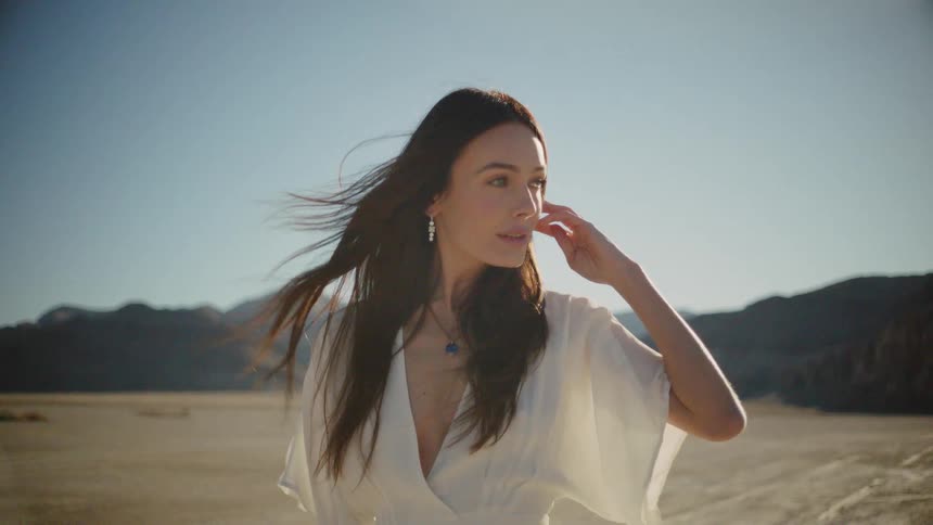 Woman is outside in desert area during day time