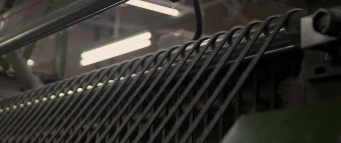 A machine moving strings of material