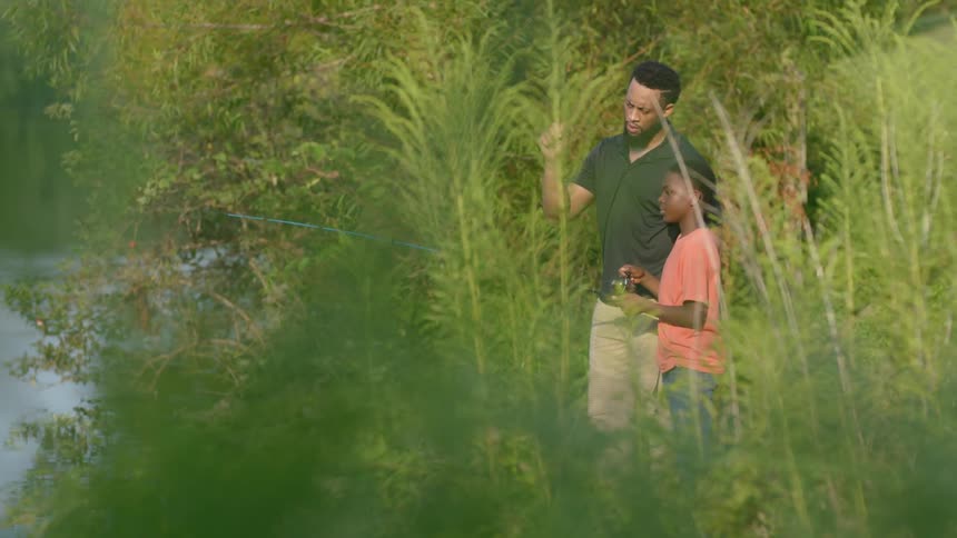 Father and boy are fishing outside