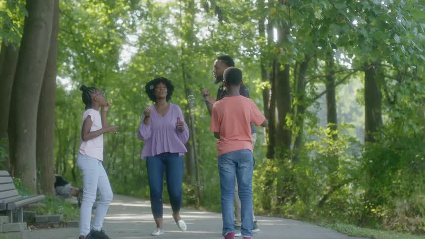 A family walk and play outside in the woods