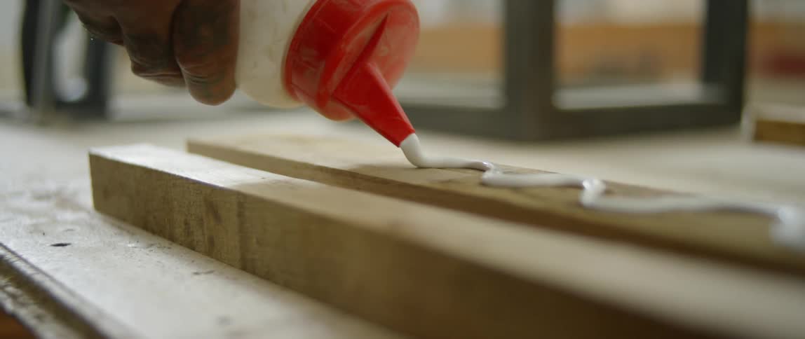 Glue is squeezed onto a piece of lumber