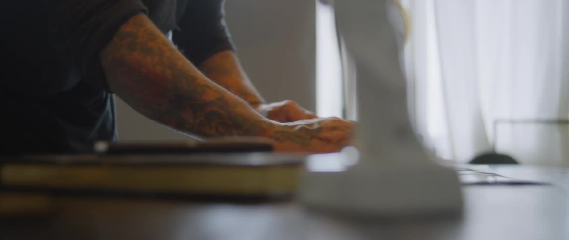 A man is placing pictures on a table