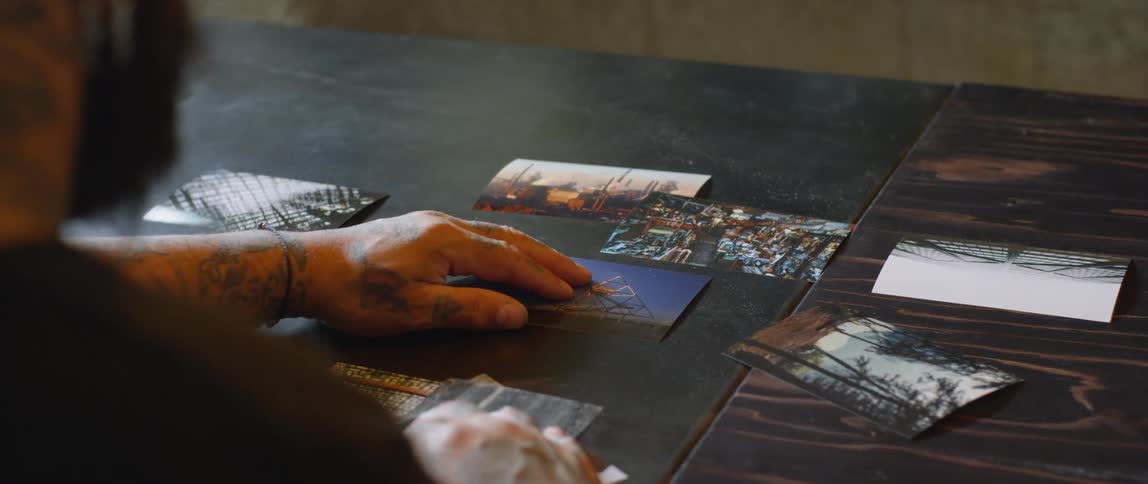 A man is putting photos on a table