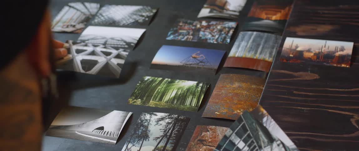 Man lays pictures out in desired order on a surface