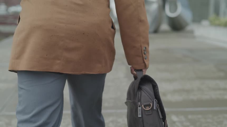 A man holding a bag walking