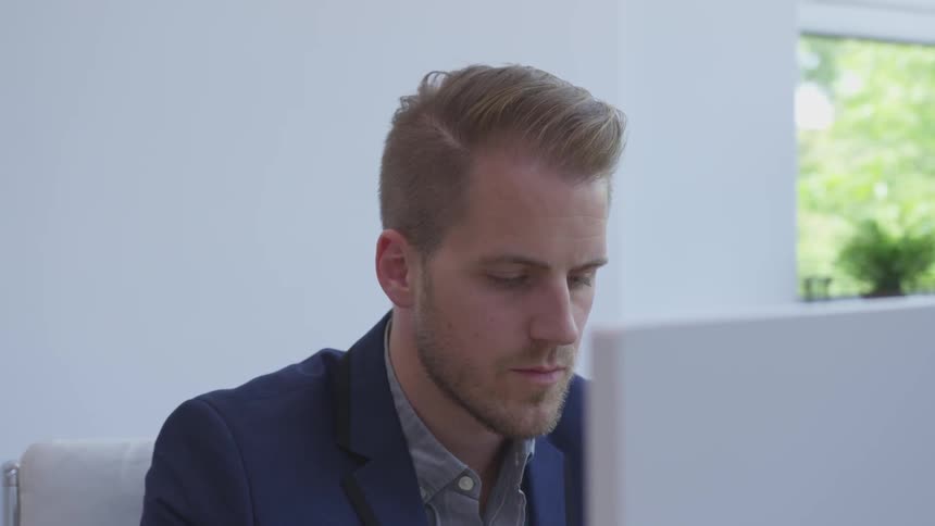 A man looking at a computer monitor