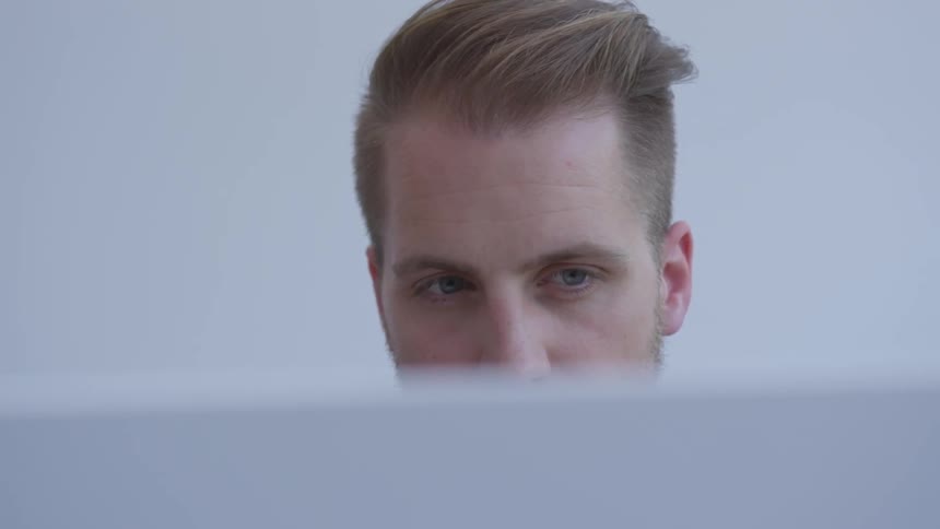 A man looking at a computer monitor