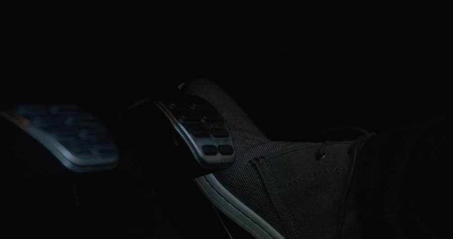 A person using pedals in a car