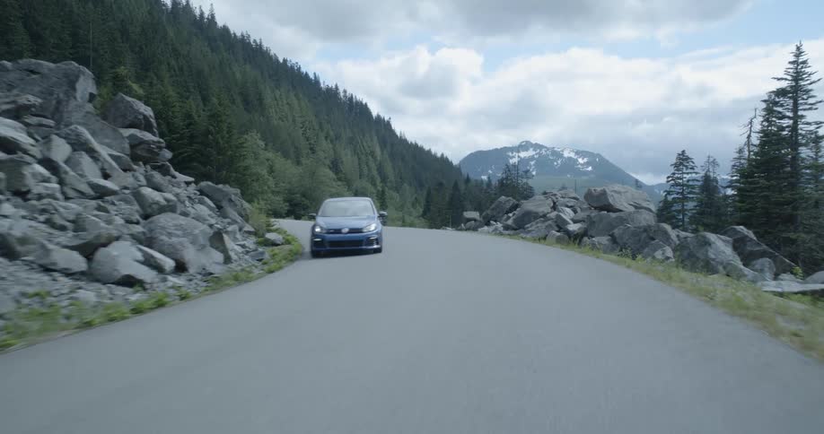 Blue car passes by on road
