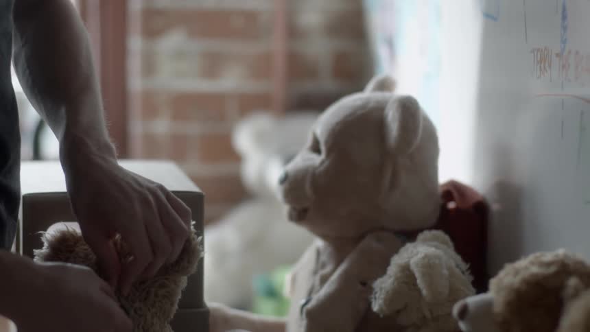 A person holding a stuffed bear