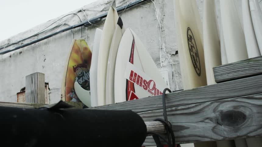 Surfboards leaning against wood