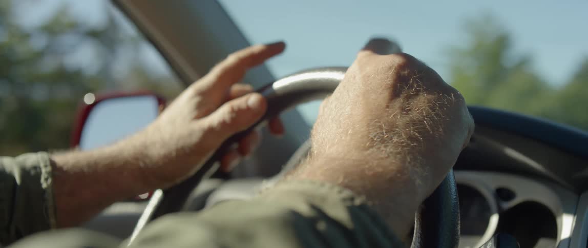 A man holding a steering wheel