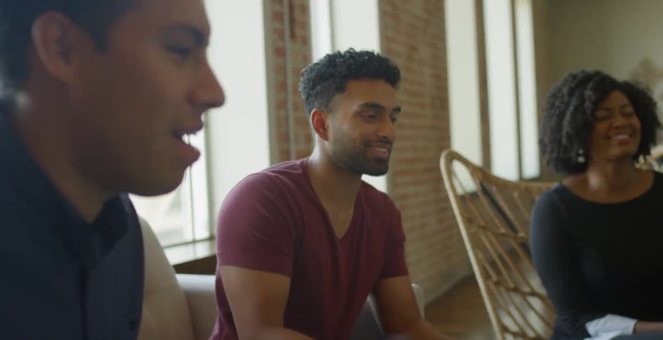 Friends share snacks while sitting in living room