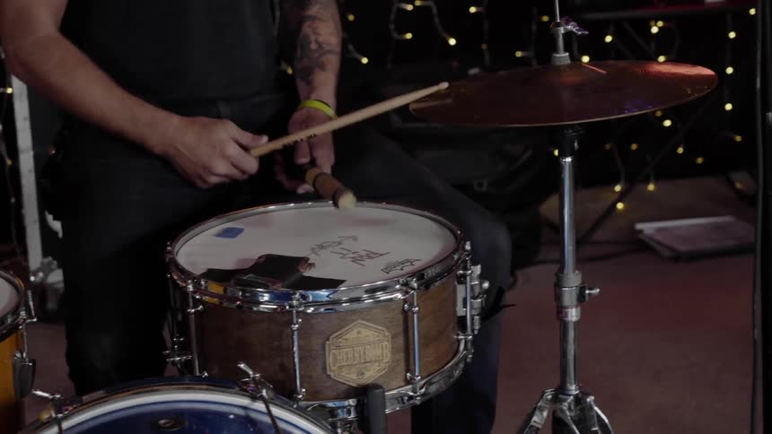 A man plays a set of drums