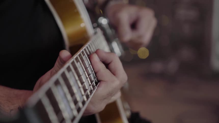 A man playing guitar indoor