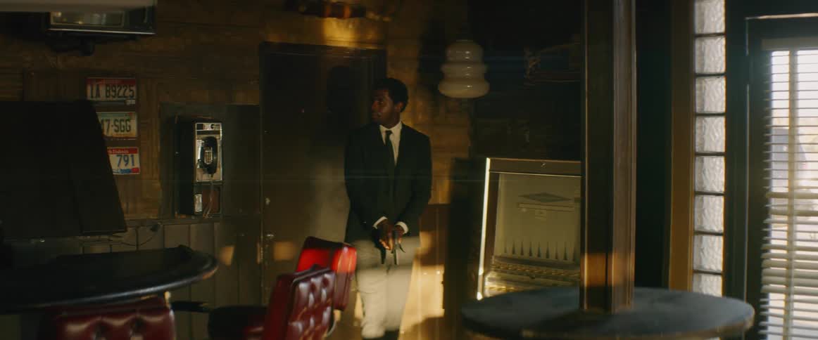 A man walks through the restaurant with a gun