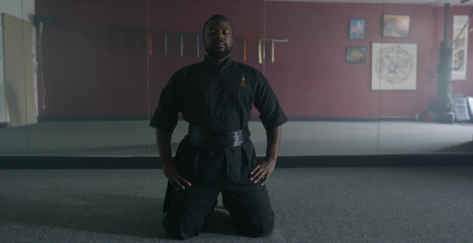 A man practicing martial arts concentration inside of a studio