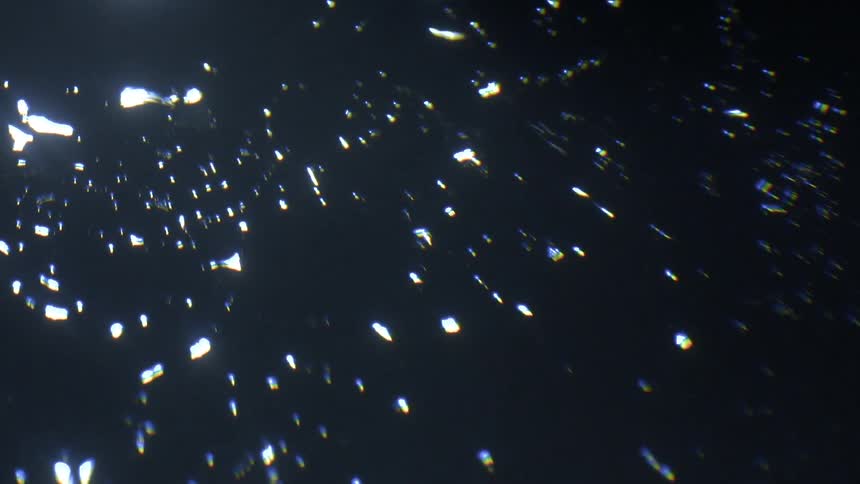 Water droplets on a camera lens with backlighting
