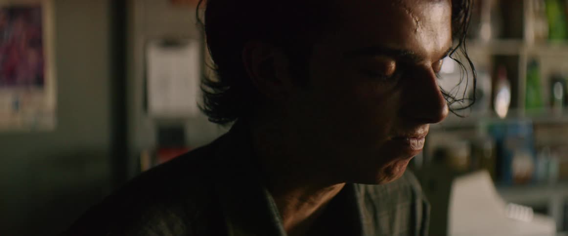 A man is closing his eyes and sitting down
